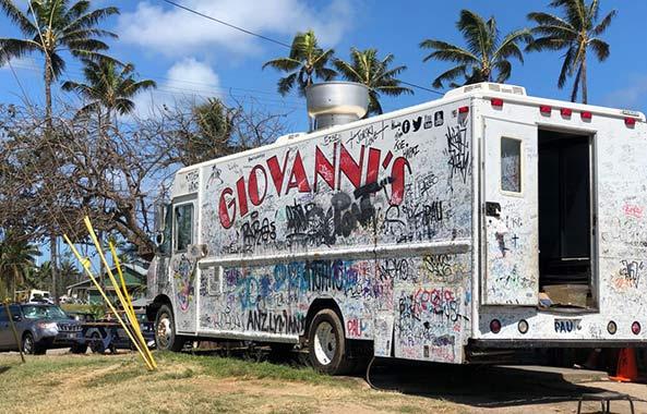 Giovannis Food Truck, white and covered in graffiti