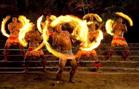 Men on stone steps spinning fire batons