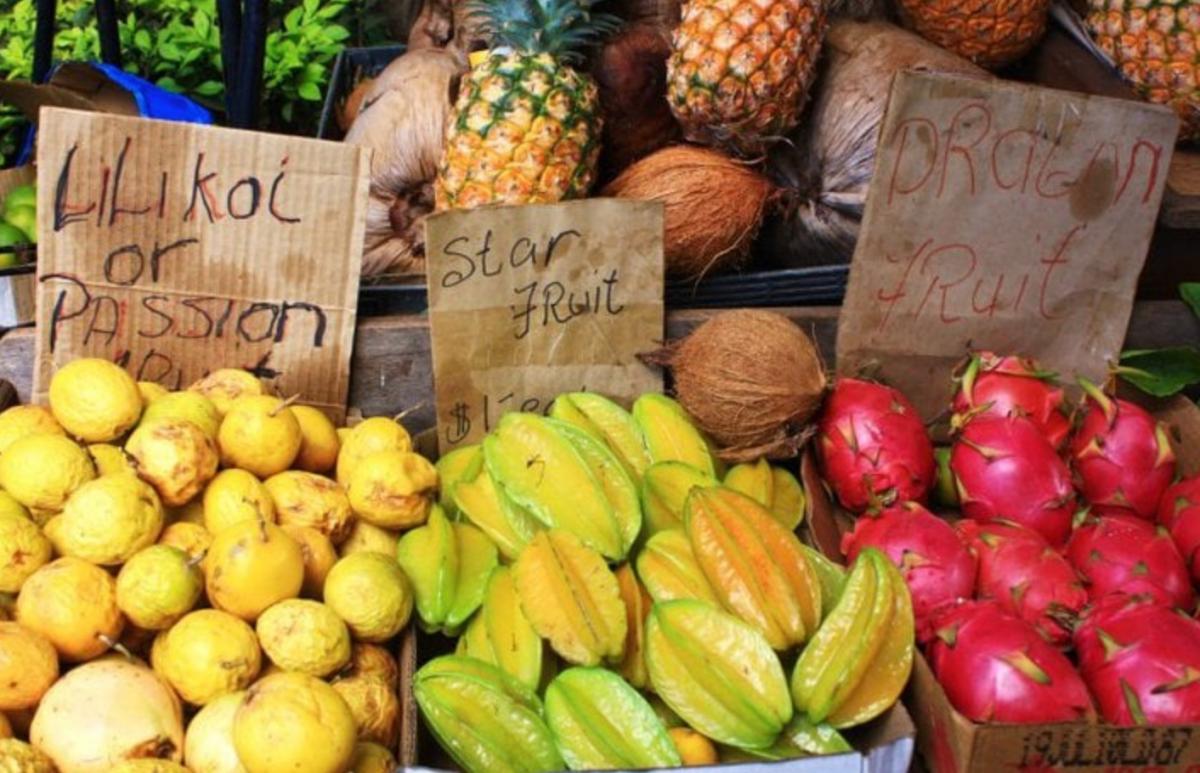 A fruit stand with piles of exotic fruits