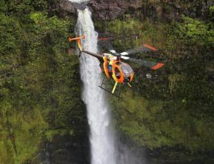 helicopter flying over a waterfall