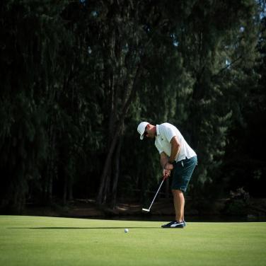 Golfer putting on the green