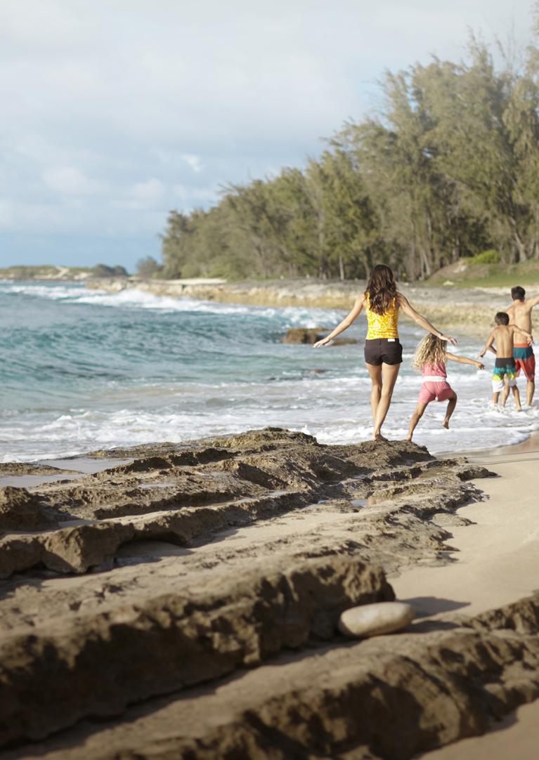 A family running on a beach