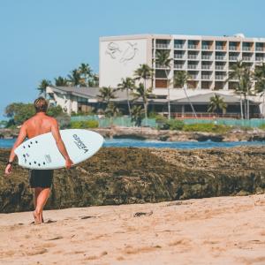 Jamie O'Brien walking with surf board
